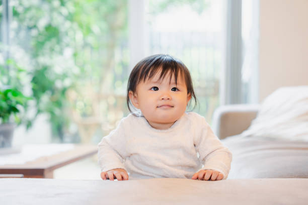 istock Baby standing up at home 1448462575