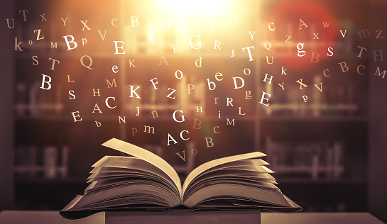 The letters float on the books in the library.\nwith a blurred background for a beautiful illustration