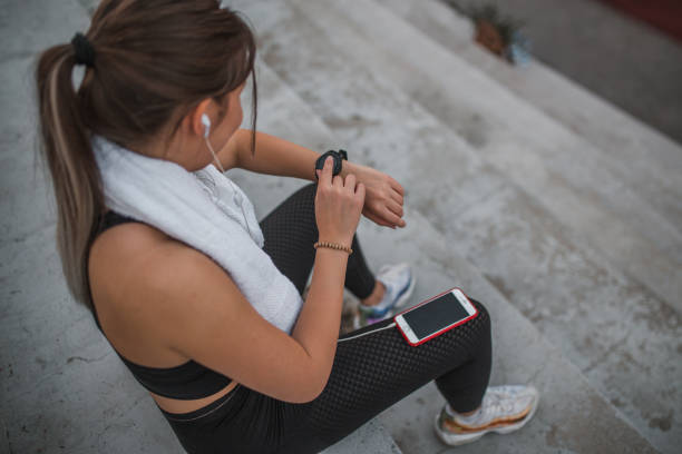 istock High angle view of a young athlete woman using smart watch 1448468610