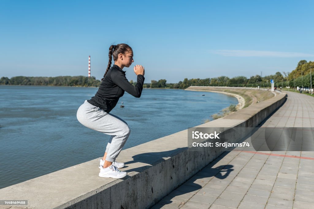 Young self loved teenage girl fitness exercises outdoor as morning routine for self-awareness of healthy life. Good posture woman stretching her muscles before workout training. Healthy habit concept Active Lifestyle Stock Photo