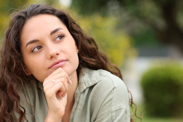 Pensive woman looking at side in a park