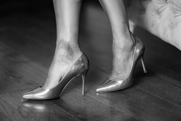 istock Silver high heels, woman wearing silver shoes. 1448470909