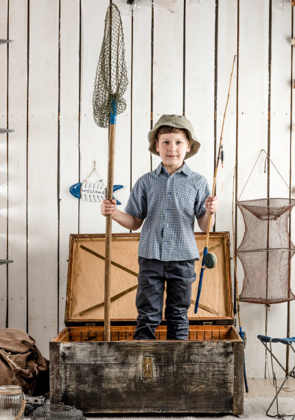 istock little boy in hat standing in chest with rod 1448470963
