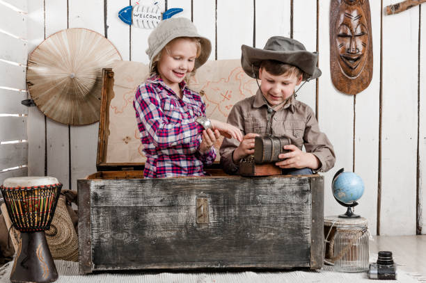 istock Smiling little boy and girl discovers treasure 1448471005