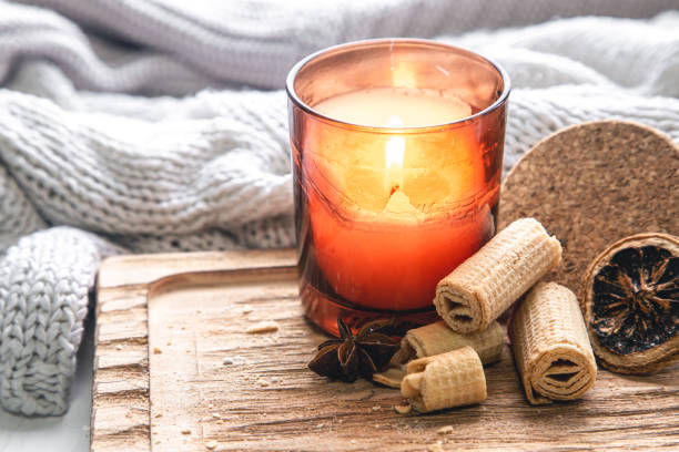 istock Burning candle and cookies on a blurred background with a knitted element. 1448471086