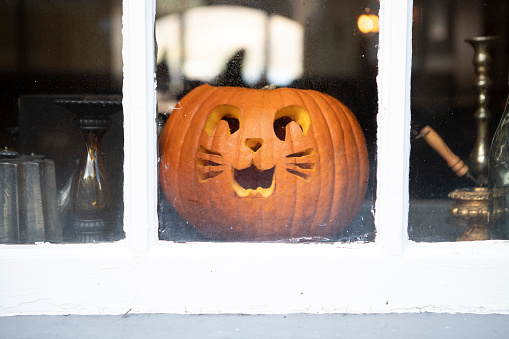 Halloween pumpkin lantern in the window of a Scottish pub