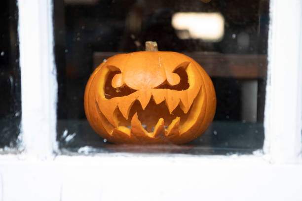 istock Scary halloween pumpkin lantern in a window 1448472192