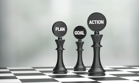 Chess pieces with Plan Action Goal written on the chessboard. Strategy And Planning Concept.