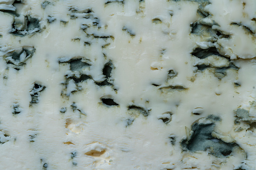 Blue cheese background and texture in the cut, top view, close up, macro