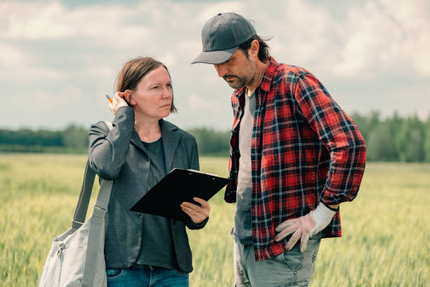 istock Mortgage loan officer assisting farmer in financial allowance application process 1448477561