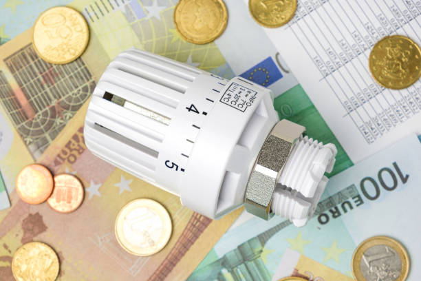 istock Thermostatic Valve Head on Euro Banknotes Background. Increasing Consumption. Cost of Electricity and Expensive Energy Concept. Price Hike. Heating Crisis. Utility Bill Saving, Conservation. Inflation 1448479886