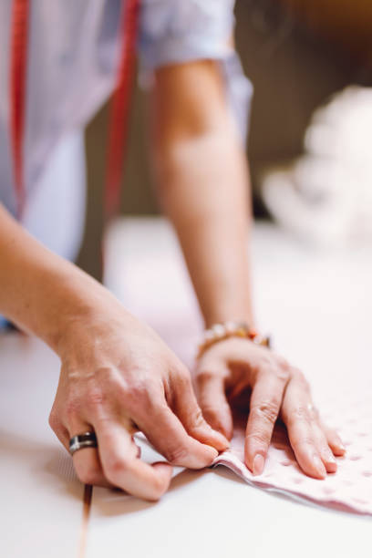 istock Seamstress dressmaker woman sewing with needles 1448480043