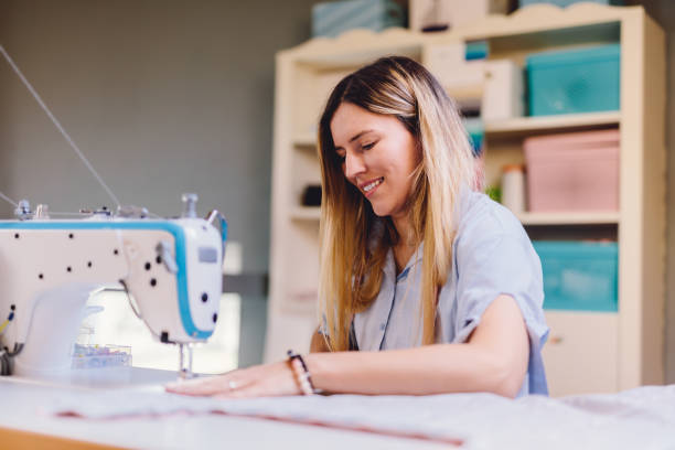 istock Seamstress dressmaker woman working with sewing machine in workshop 1448480071