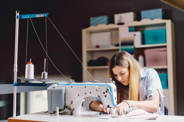 istock Seamstress dressmaker woman working with sewing machine in workshop 1448480077