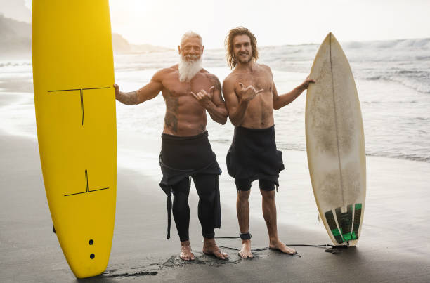 istock Multi generational family having fun while surfing on beach - Focus on guy face 1448480804