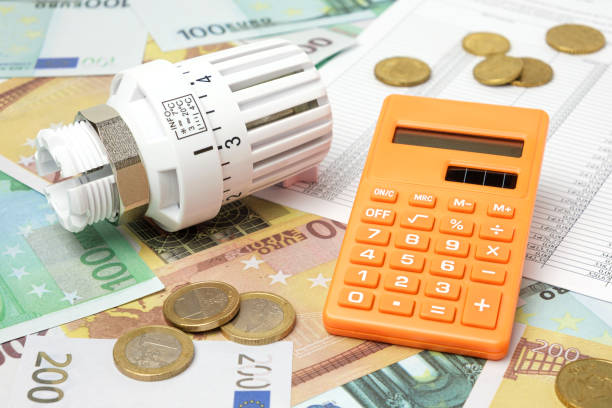 istock Thermostatic Valve Head, Calculator on Euro Banknotes Background. Increasing Consumption. Cost of Electricity, Energy Concept. Price Hike. Heating Crisis. Utility Bill Saving, Conservation. Inflation 1448481166