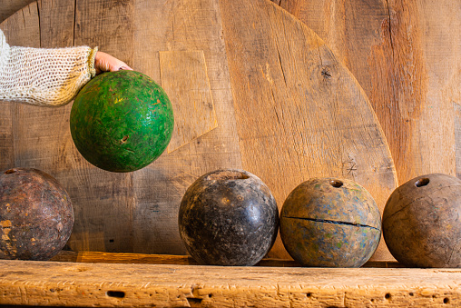 Antique bowling wooden balls in old restored wooden furniture showroom