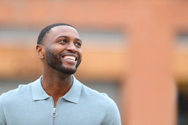 istock Happy black man looking above in the street 1448482500