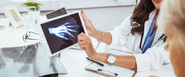 istock Orthopedic surgeon looking at X-Rays after surgery procedure has been completed 1448486975