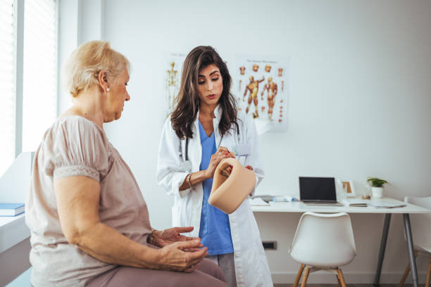 istock Doctor putting a neck brace on a senior patient 1448486993