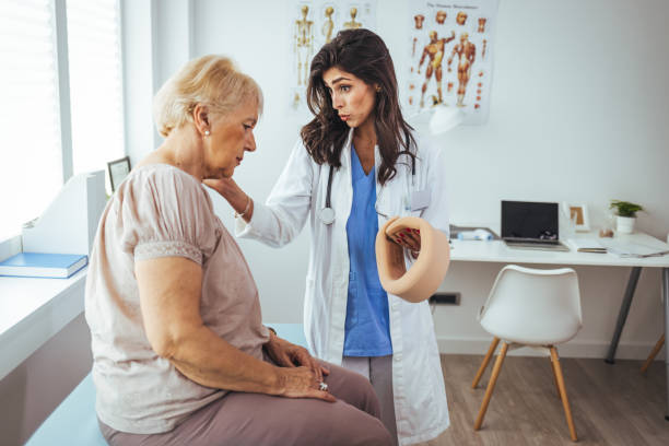 istock Doctor putting a neck brace on a senior patient 1448487036