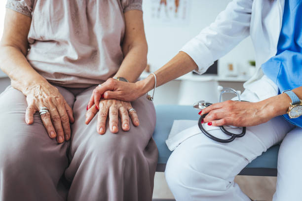 istock Health worker holding patient's hand. 1448487148