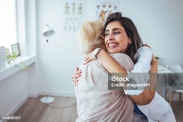 Shot Of A Young Nurse Caring For A Senior Woman Stock Photo - Download Image Now - Patient, Embracing, Laughing