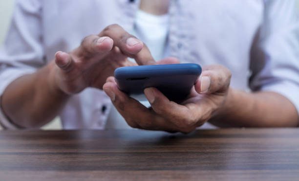 istock Hand with smart phone black screen isolated on white 1448487493