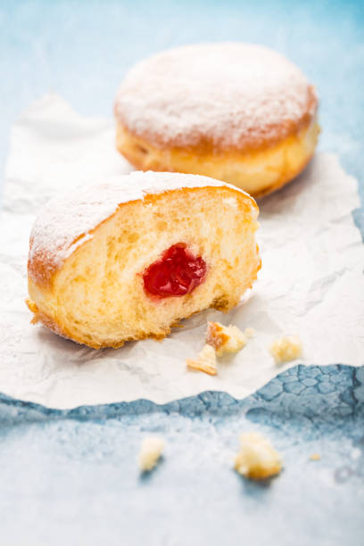 istock German donuts - Berliner filled with strawberry jam with icing sugar 1448488548