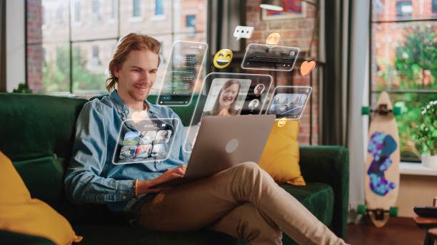 istock Young Handsome Man Using Laptop Computer To Check Social Media, Listen To Music and Read Emails. Creative Person Catching Up With Friends Online. 3D Visualization of Online Platforms Concept. 1448488743