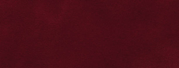 istock Texture of velvet matte dark red background, macro. Suede wine fabric with pattern. Textile leather backdrop, 1448488889