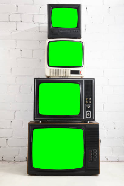 istock Four vintage green screen televisions with a white brick background. 1448489180