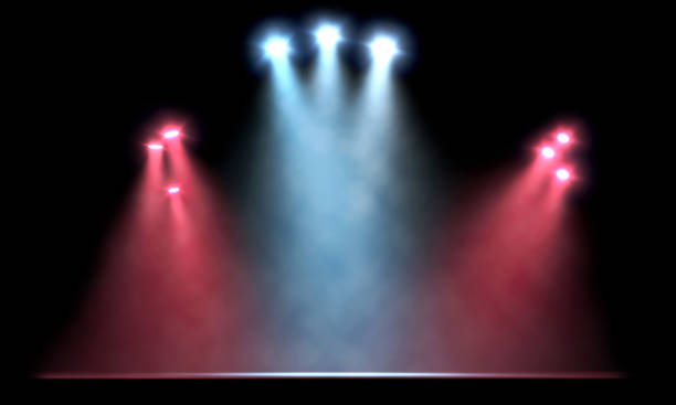 istock Bright white spotlights illuminating an empty stage with red lights on the sides 1448490467