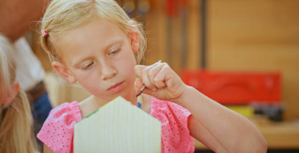 istock Girl painting model house 1448491895