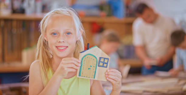 istock Girl showing small model house 1448491909