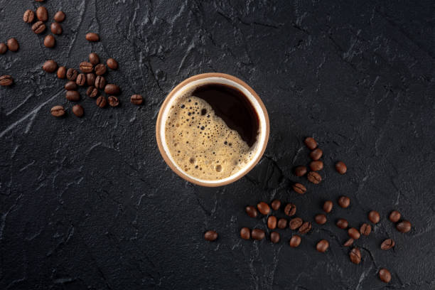 istock Coffee cup and beans, top shot on a dark background with copy space 1448495920