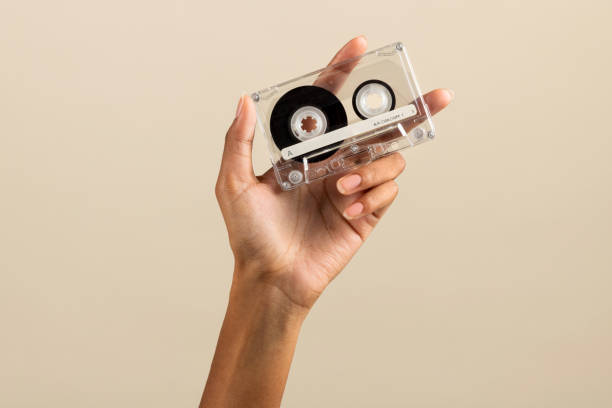 istock Black female hand showing plain cassette tape 1448497021