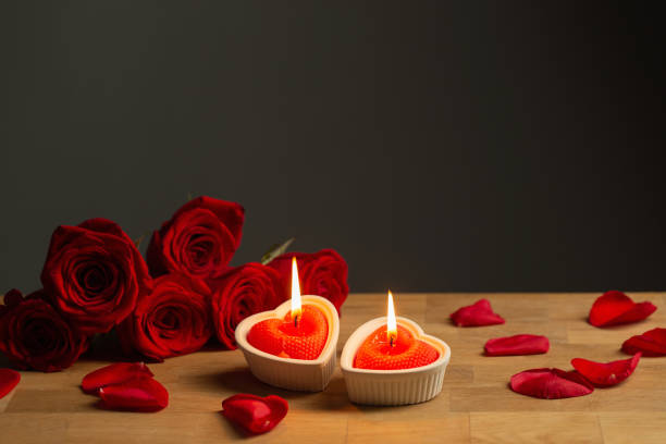 istock red roses with burning candles on dark background 1448498962