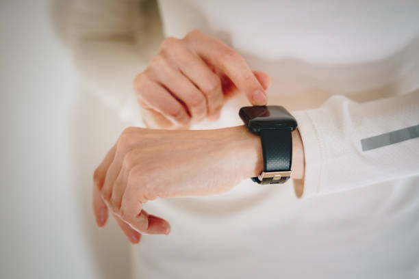 istock Woman tracks pulse on a smart watch 1448499929