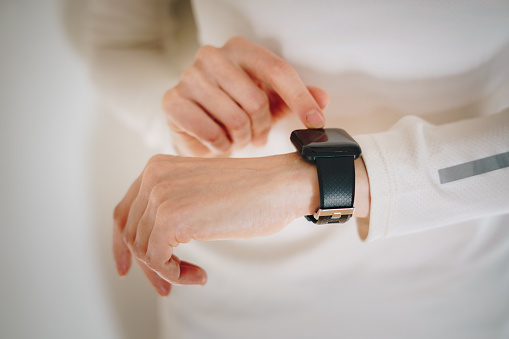 Closeup of woman tracking pulse on a smart watch