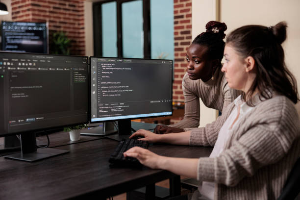 istock African american team leader looking for unknown anomalies in security network blockchain code. 1448500262