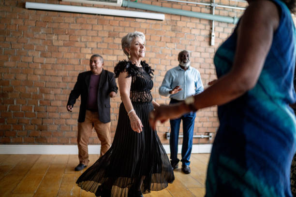 istock Senior woman dancing with her friends on a dance hall 1448500511