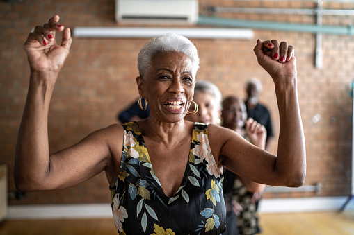 Senior woman dancing with her friends on a dance hall