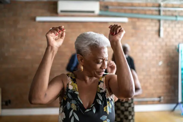 Photo of Senior woman dancing with her friends on a dance hall