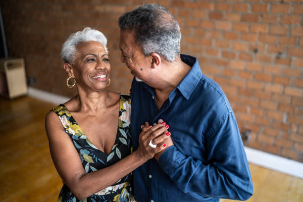 Senior couple dancing waltz in dance hall