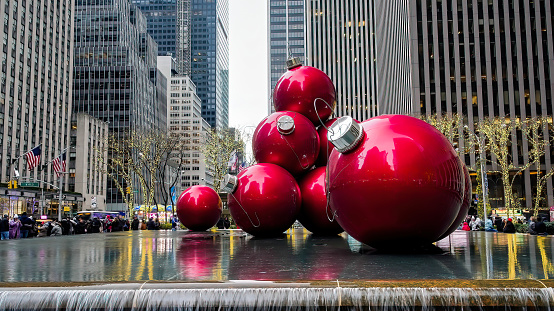 New York, NY, USA - December 10, 2022: Giant Christmas balls decoration at 6th Av with street view and architecture