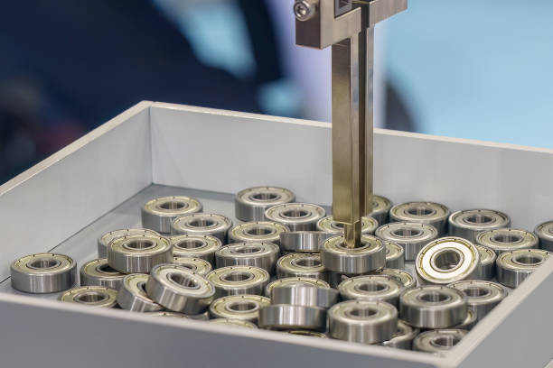 istock The automatic  robotic arm gripping the rolling bearing parts. 1448502115