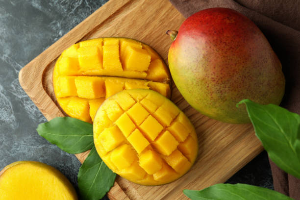 istock Tasty ripe mango fruit on black smokey table 1448502186