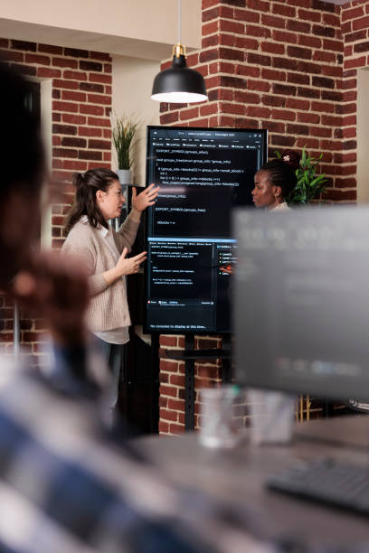 istock Multiethnic developer team talking about rising number of system security breaches. 1448502251