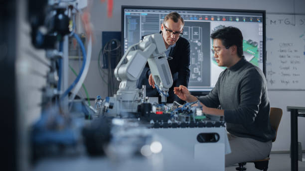 istock Concentrated Teacher Helping Asian Engineer Student Working with Screwdriver and Computer Motherboard. Science, Robotics and Engineering Concept at Modern University of Technology. Medium Shot 1448502275